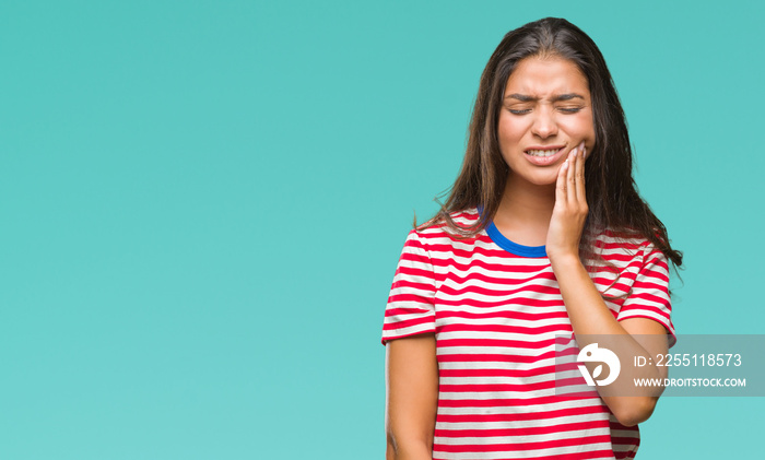 Young beautiful arab woman over isolated background touching mouth with hand with painful expression because of toothache or dental illness on teeth. Dentist concept.