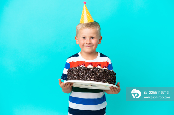 Little Russian boy holding birthday cake over isolated background