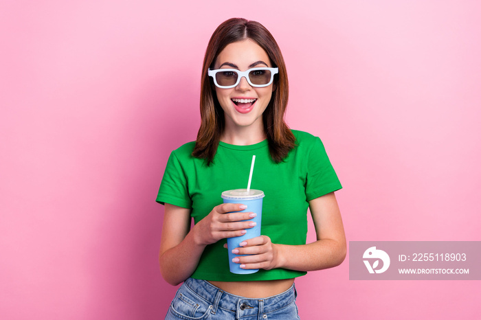 Portrait of positive nice person toothy smile hands hold soda drink cup isolated on pink color background