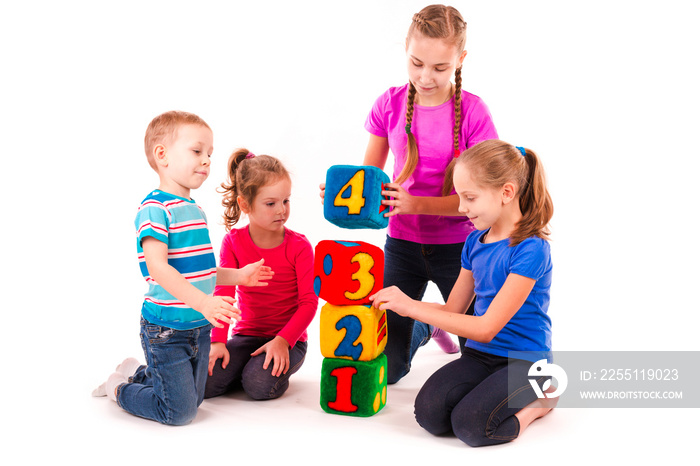 Happy kids holding blocks with numbers over white background