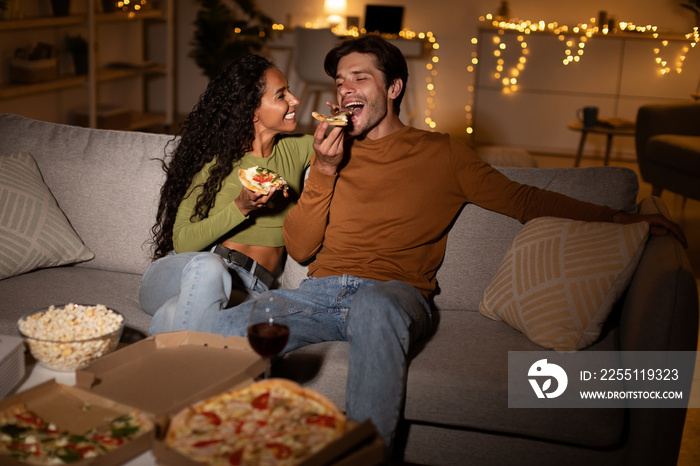 Cheerful Husband And Wife Eating Pizza Watching Movie At Home