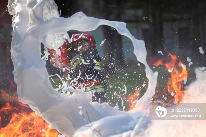 Firefighters extinguish a fire. Lifeguards with fire hoses in smoke and fire.