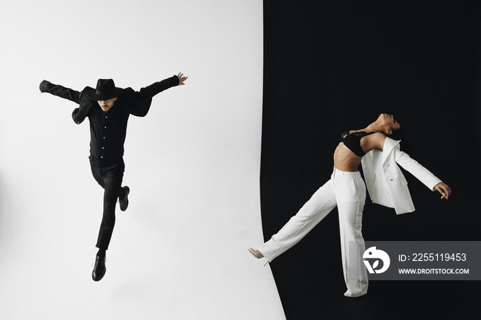 Creative photo of european man in black suit and young african american woman with curly hair on black and white background