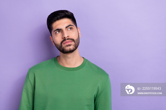 Photo of thoughtful handsome suspicious man dressed green long sleeve minded thinking look empty space isolated on violet color background