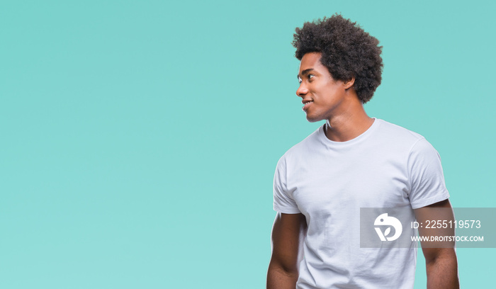 Afro american man over isolated background looking away to side with smile on face, natural expression. Laughing confident.