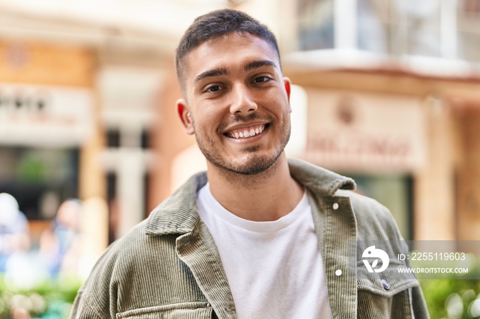 Young hispanic man smiling confident standing at street