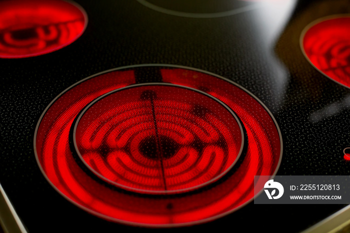 close-up of a round red glowing induction stove