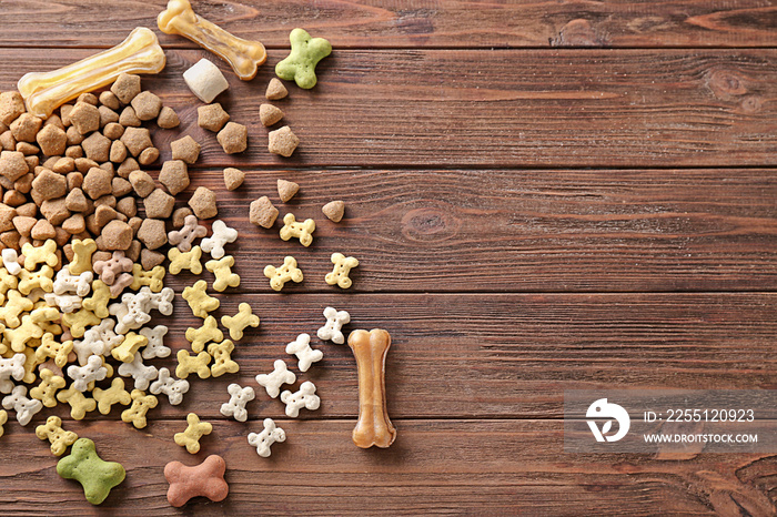 Pile of pet food on wooden background