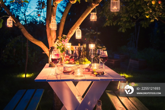 Table for dinner full of cheese and meats at dusk