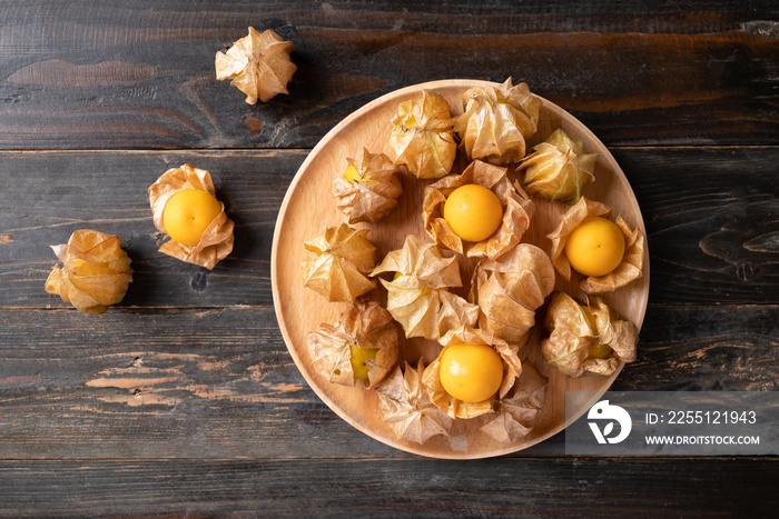 Cape gooseberry or golden berry (Physalis peruviana) on wooden background, Table top view