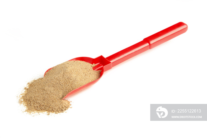 Beach shovel stuck with sand isolated on a white background