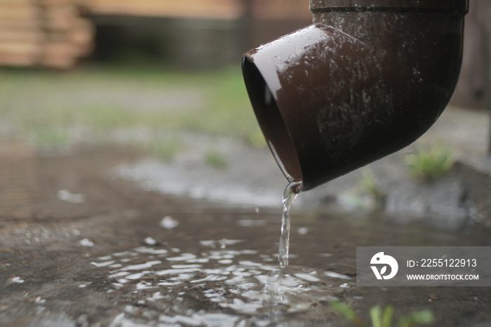 Rain Water Flows From A Plastic Drainpipe