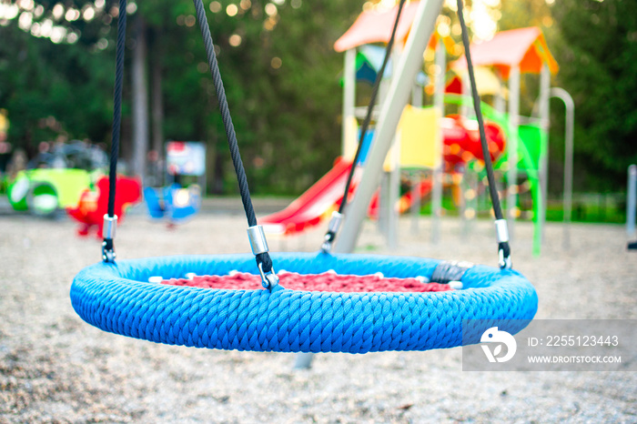 Colourful modern kids playground on the sunset.