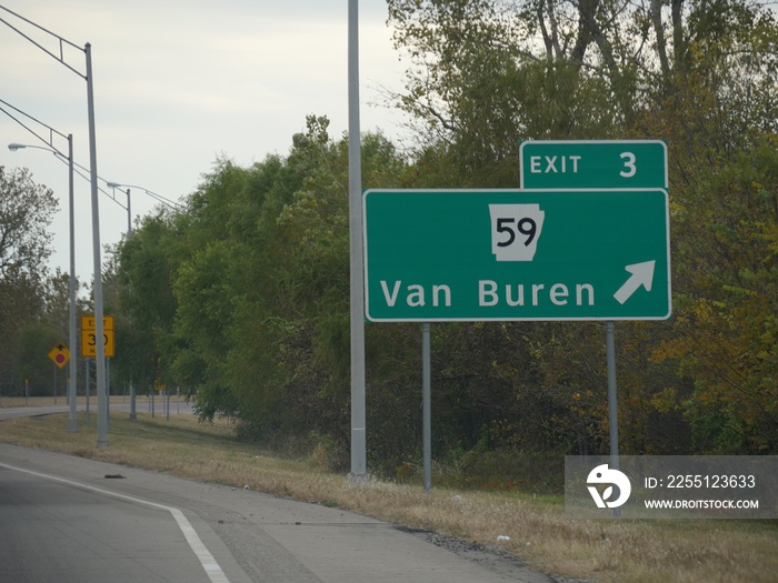 Directional sign along the road with exit directions to Van Buren, Arkansas.