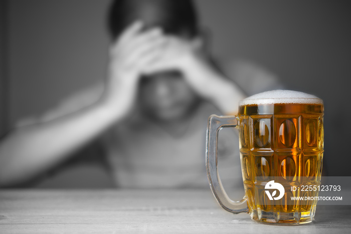 glasses of Beer and background images are male headaches. The result of excessive alcohol consumption.