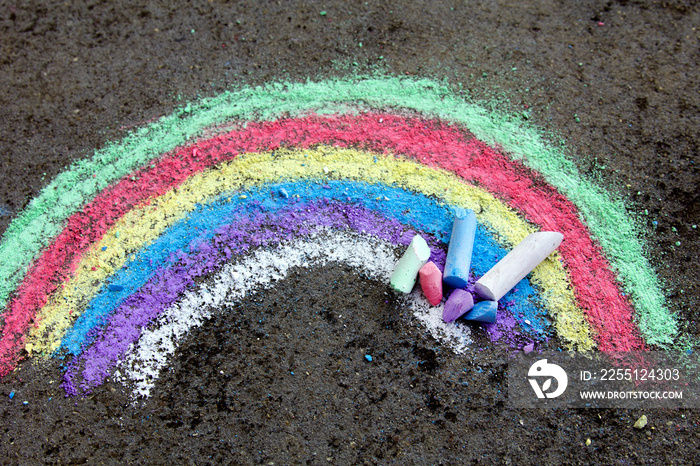 chalk drawing on asphalt: colorful rainbow