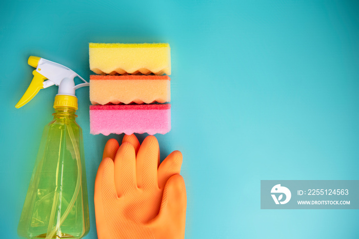 Home cleaning products on blue background. Close up. Copy space.