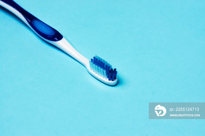 Tooth and toothbrush on blue background