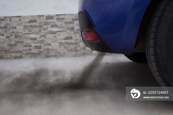 Representation of environmental pollution, black exhaust fumes coming out of a car’s muffler