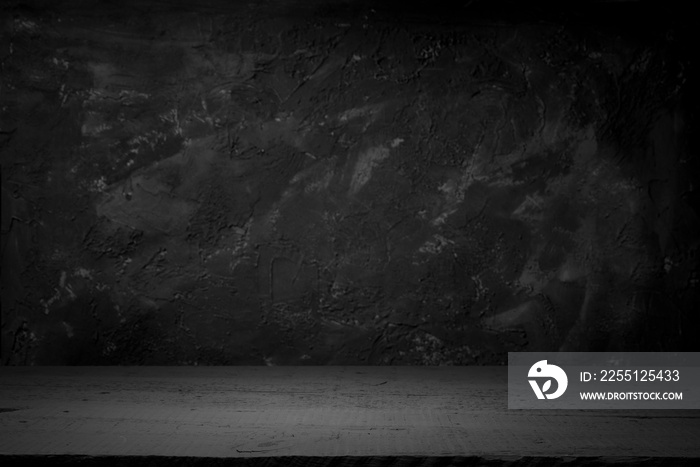 cement floor in dark room with spot light. black background.