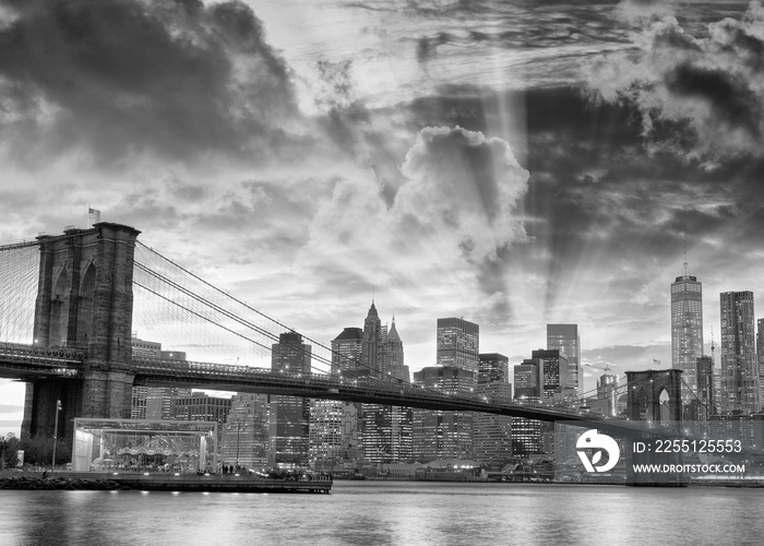 Black and white view of Brooklyn Bridge and Downtown Manhattan at sunset