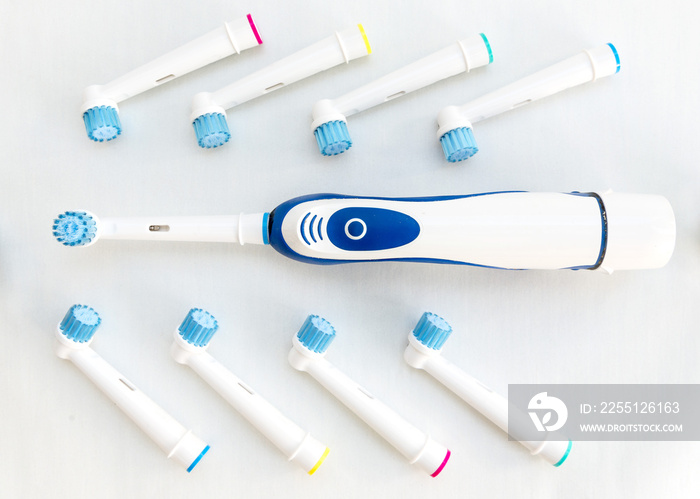 Electronic toothbrush with toothbrush heads on white