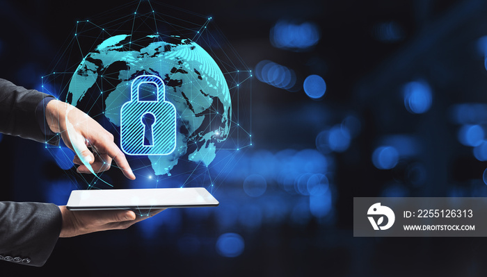 Close up of hand pointing at smartphone with abstract glowing globe hologram with security padlock icon on blurry office interior bokeh background with mock up place.