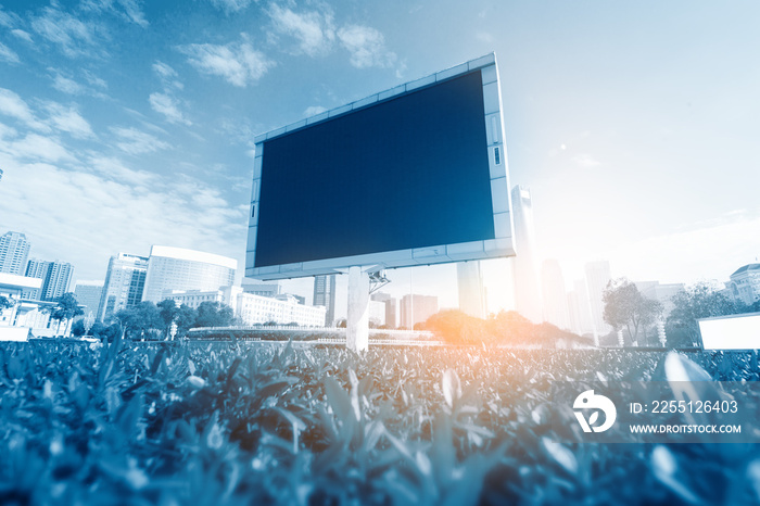 Big white blank billboard in modern city over blue sky background.