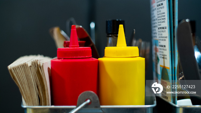 A close up of a traditional bottle of ketchup and mustard, this classic design of bottle is recognised internationally which originated from America