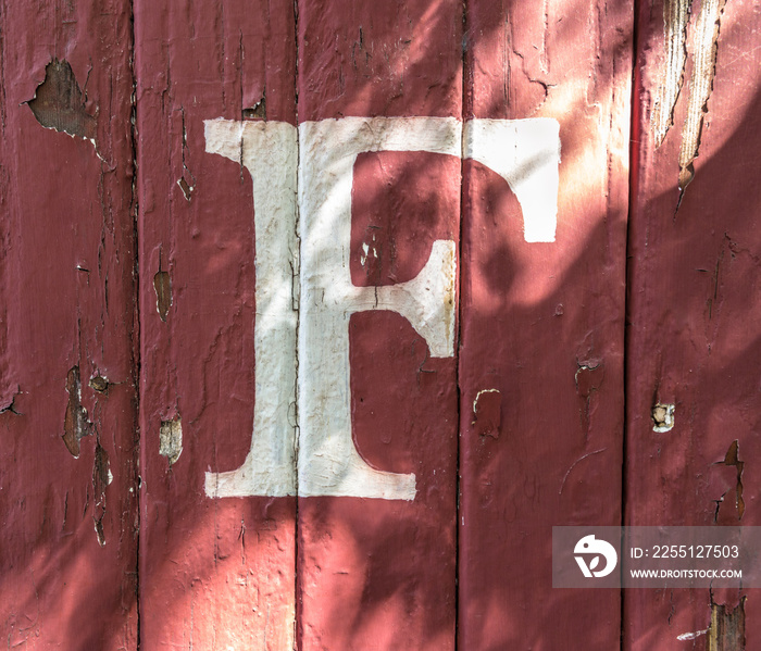 F on red-Painted Wood Siding