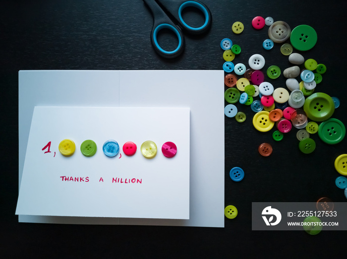 Creating Thank You card from colourful buttons. Thanks a million.