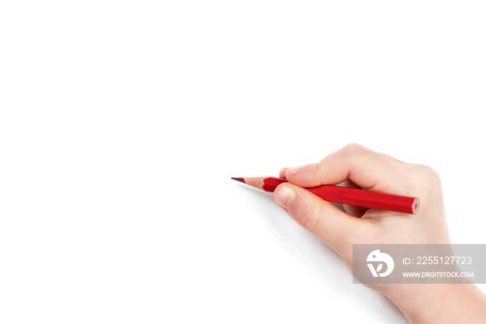 Child hand holding a red pencil and getting ready to draw, isolated on a white background