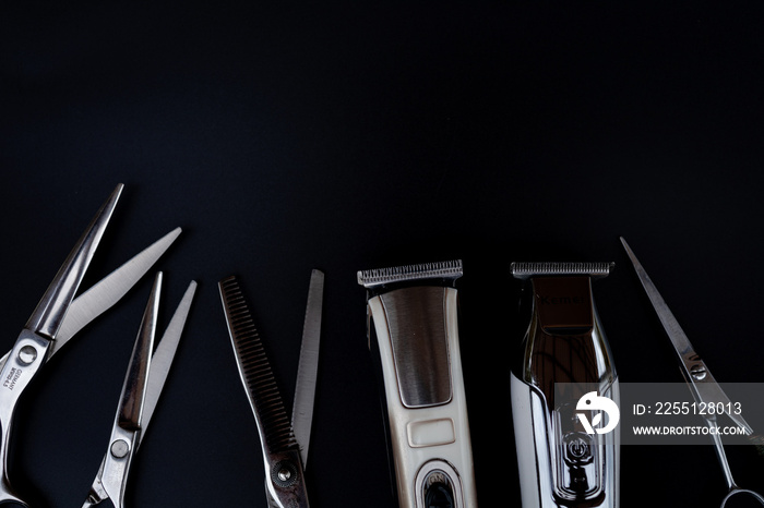 A set of hair cut tools on black background for cutting barber beard salon