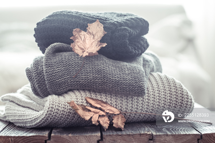 stack of cozy knitted sweaters in different colors.