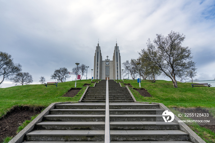 Horizontal shot of church in Akureyri city in the northern part of Iceland. Stairs used as leading lines towards the church tower. Icelandic traveling, architecture and landmark concept.