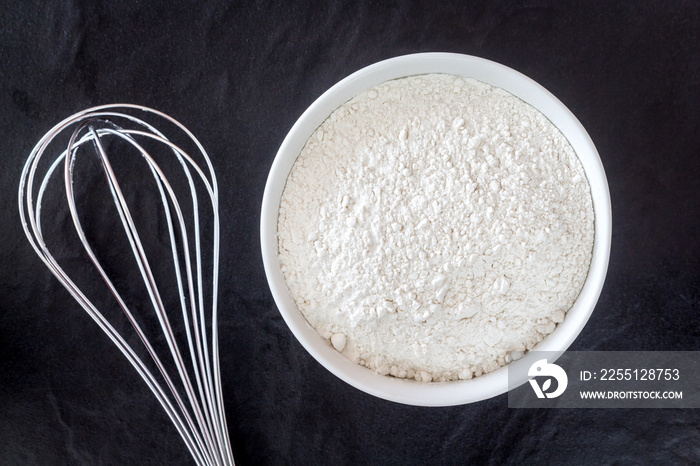 Baking background with flour on black table