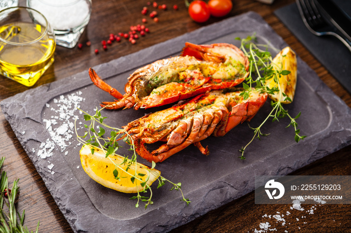 Lobster with flavored butter. Herb butter, lemon. Delicious healthy traditional food closeup served for lunch in modern gourmet cuisine restaurant