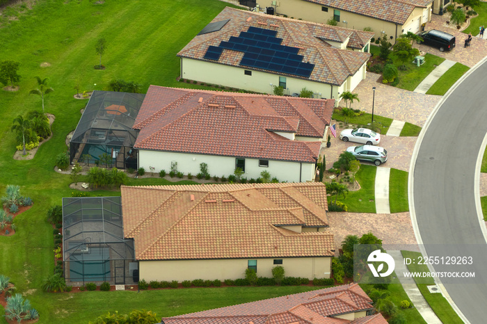 Aerial view of expensive modern houses with outside swimming pools covered with mosquito mesh on metal frame for insect protection in Florida closed living club