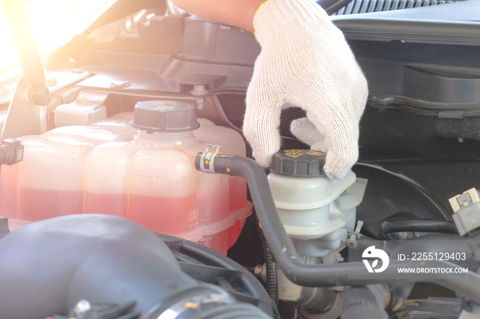 Close up hand a  man opening to brake fluid tank for check - Car maintenance