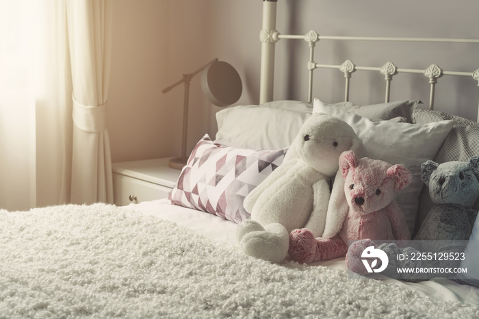 Group of teddy bear on bed with softlight in the morning