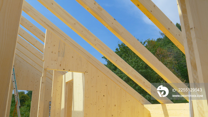 Uncovered roof of a modern cross laminated timber house reveals the clear sky.