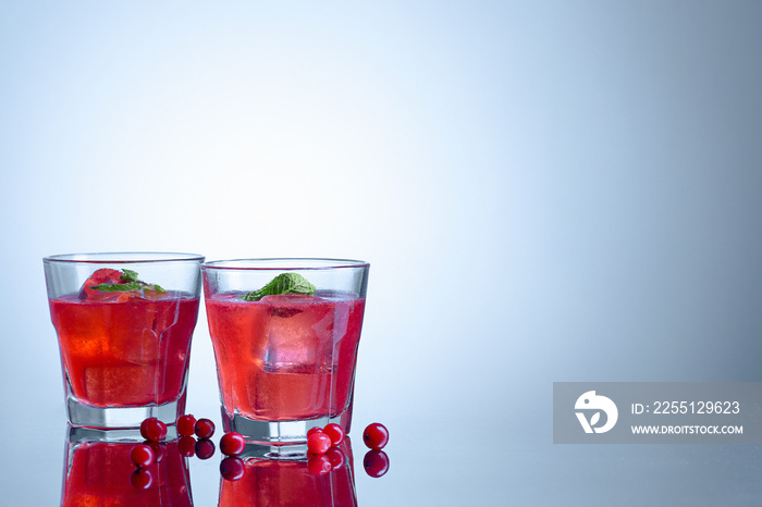 closeup of a cape cod cocktail or vodka cranberry on a blue background