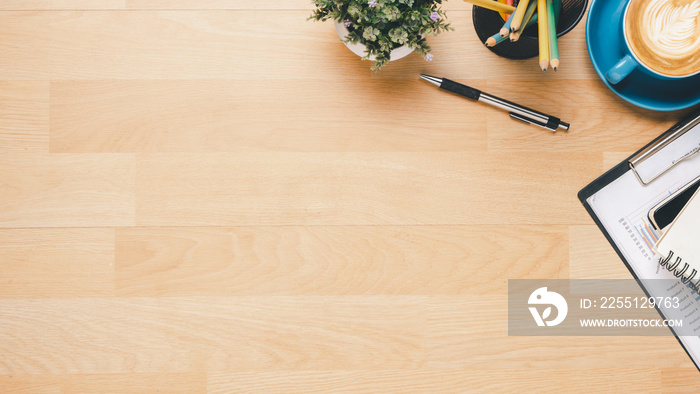 Wooden Office desk with notebook, pen and cup of coffee, Top view wth copy space, Flat lay.