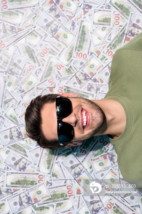 Vertical portrait of cheerful person laying usd banknotes money ocean isolated on money background