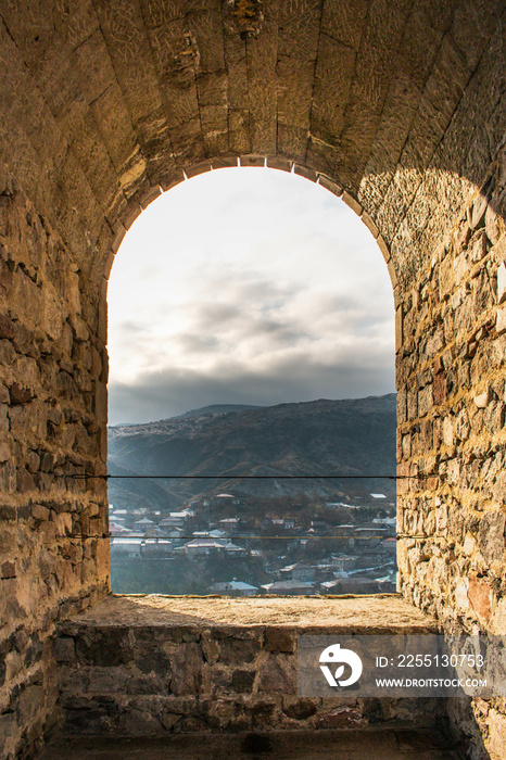 Stone arched window of Rabati Castle, Akhaltsikhe, Georgia, overlooking the town and mountains.