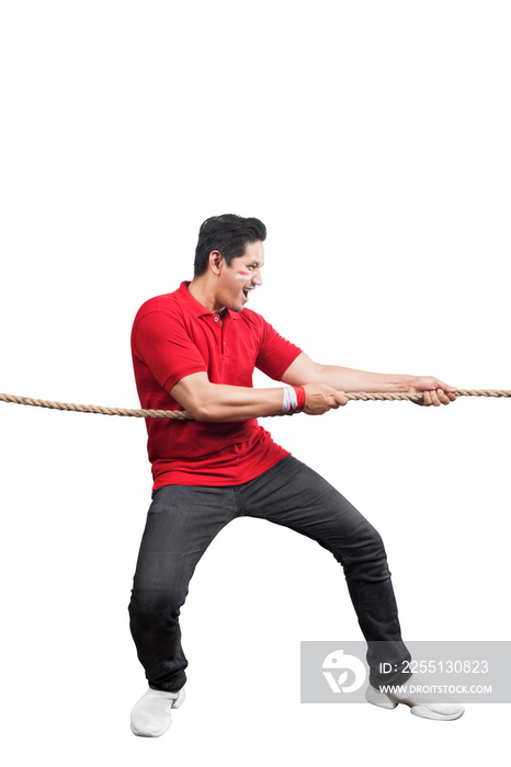 Indonesian men celebrate Indonesian independence day on 17 August with the tug of war contest