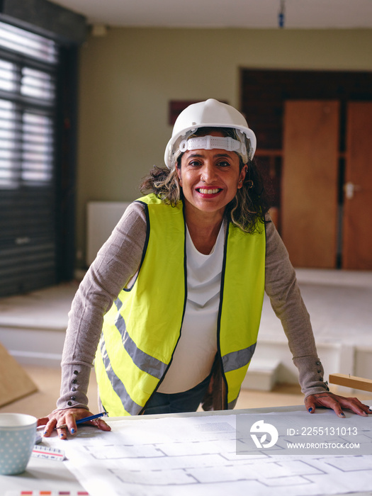 Portrait of woman in hardhat and reflective vest