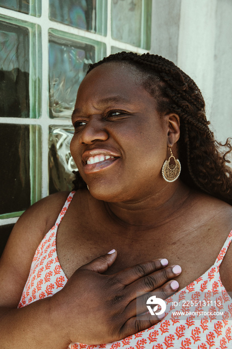 closeup of African American woman with hand on heart