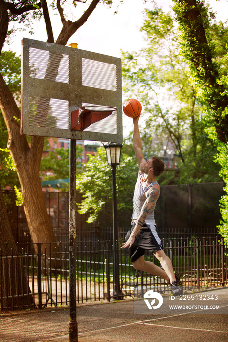 Men playing basketball on court