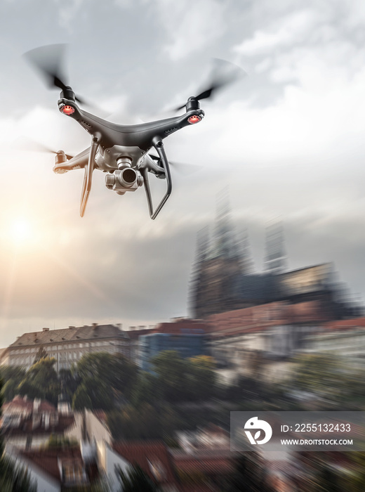 Modern dark drone in flight over the city.